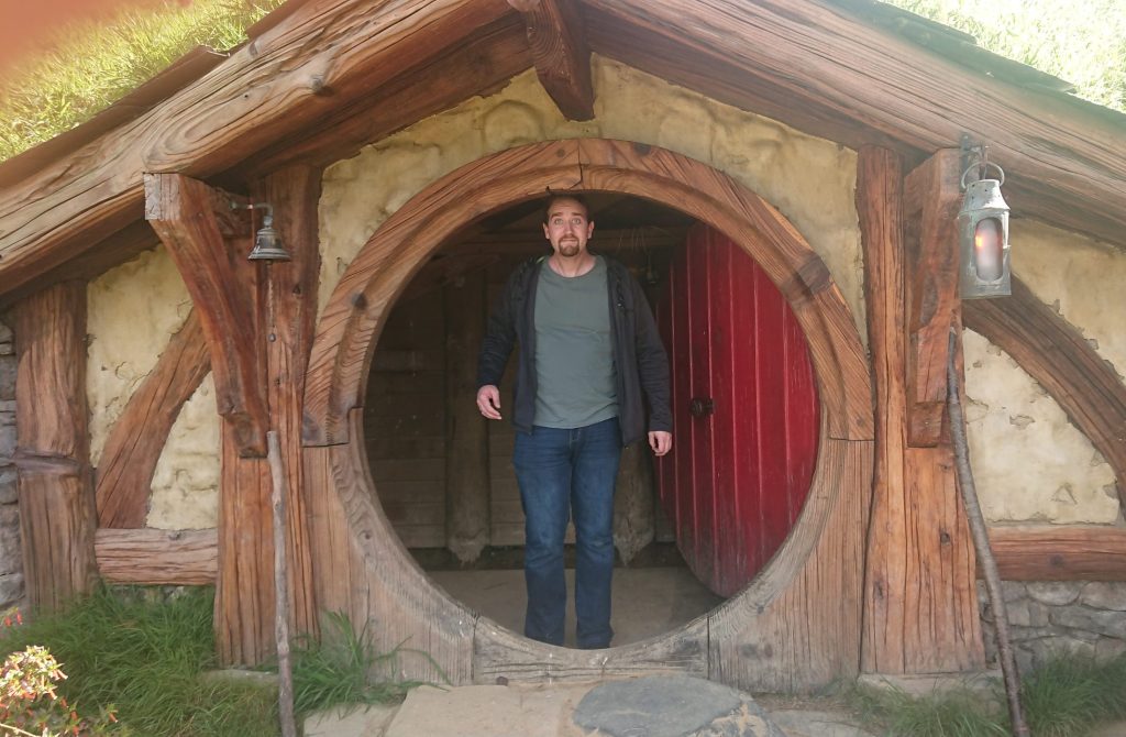 Me standing in a hobbit hole at Hobbiton