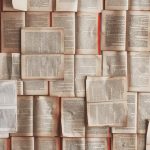 A collection of open books spread across a surface