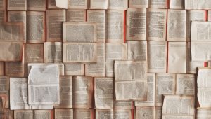 A collection of open books spread across a surface
